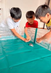 Bambini che giocano con il loro criceto nel box per criceti Omlet.